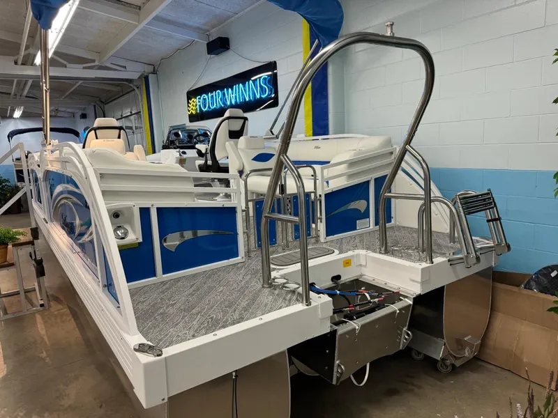 Slide: The Image of 2024 JC Neptoon 23 TT DSL pontoon boat in showroom, rear view with ladder and seating. - 43