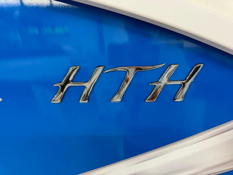 Slide: The Image of Chrome "HTH" emblem on blue JC Neptoon 23 TT DSL, 2024 model. - 45