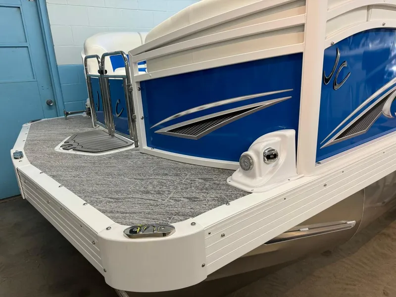 Slide: The Image of 2024 JC Neptoon 23 TT DSL pontoon boat, blue and white design, rear view. - 49