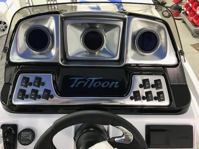 Slide: The Image of 2024 JC Neptoon 23 TT DSL boat dashboard with controls and steering wheel. - 6