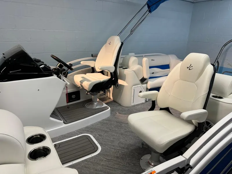 Slide: The Image of 2024 JC Neptoon 23 TT DSL boat interior with white seating and modern helm. - 9