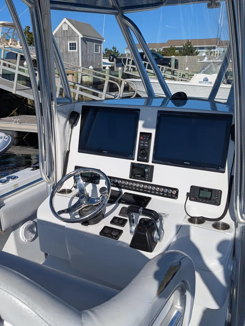 Slide: The Image of 2019 Contender 30T boat helm with dual screens and controls. - 10