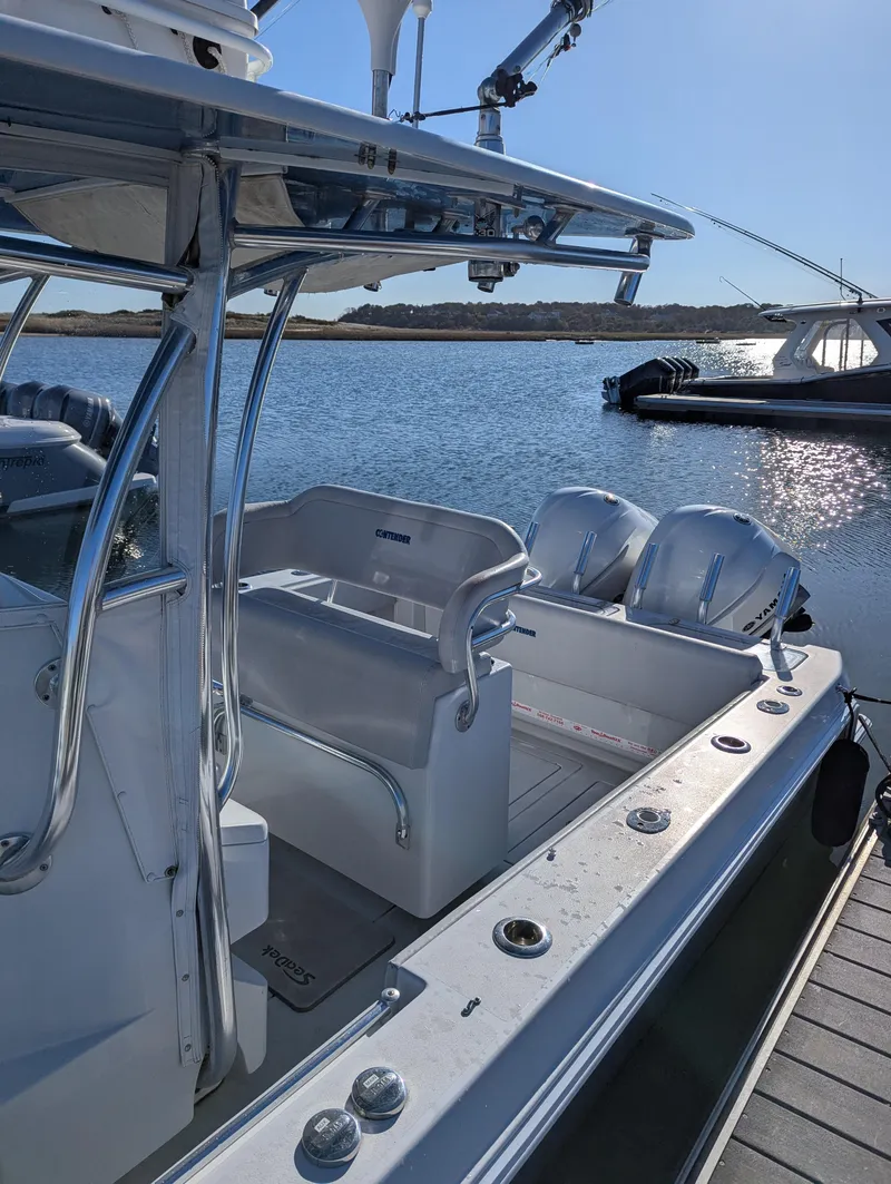 Slide: The Image of 2019 Contender 30T boat docked by the water on a sunny day. - 2