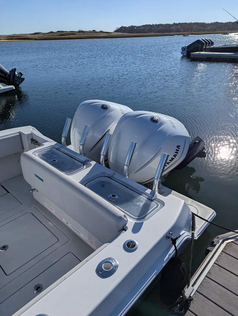 Slide: The Image of 2019 Contender 30T boat with dual Yamaha outboard engines on a calm lake. - 3