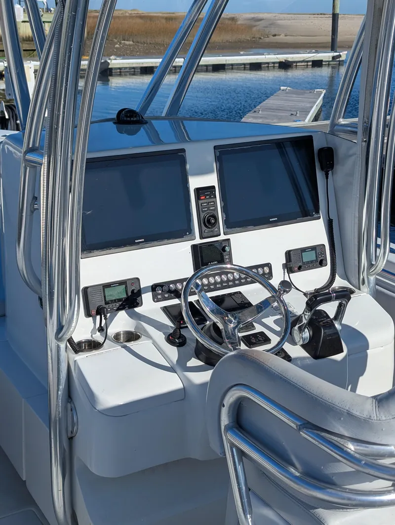 Slide: The Image of 2019 Contender 30T boat helm with dual screens and controls at marina. - 5