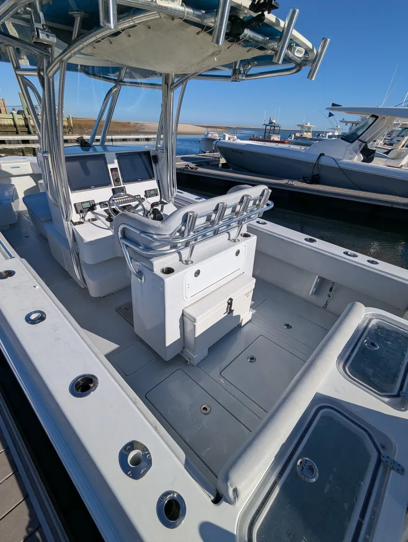 Slide: The Image of 2019 Contender 30T boat interior with helm, seating, and storage compartments. - 6