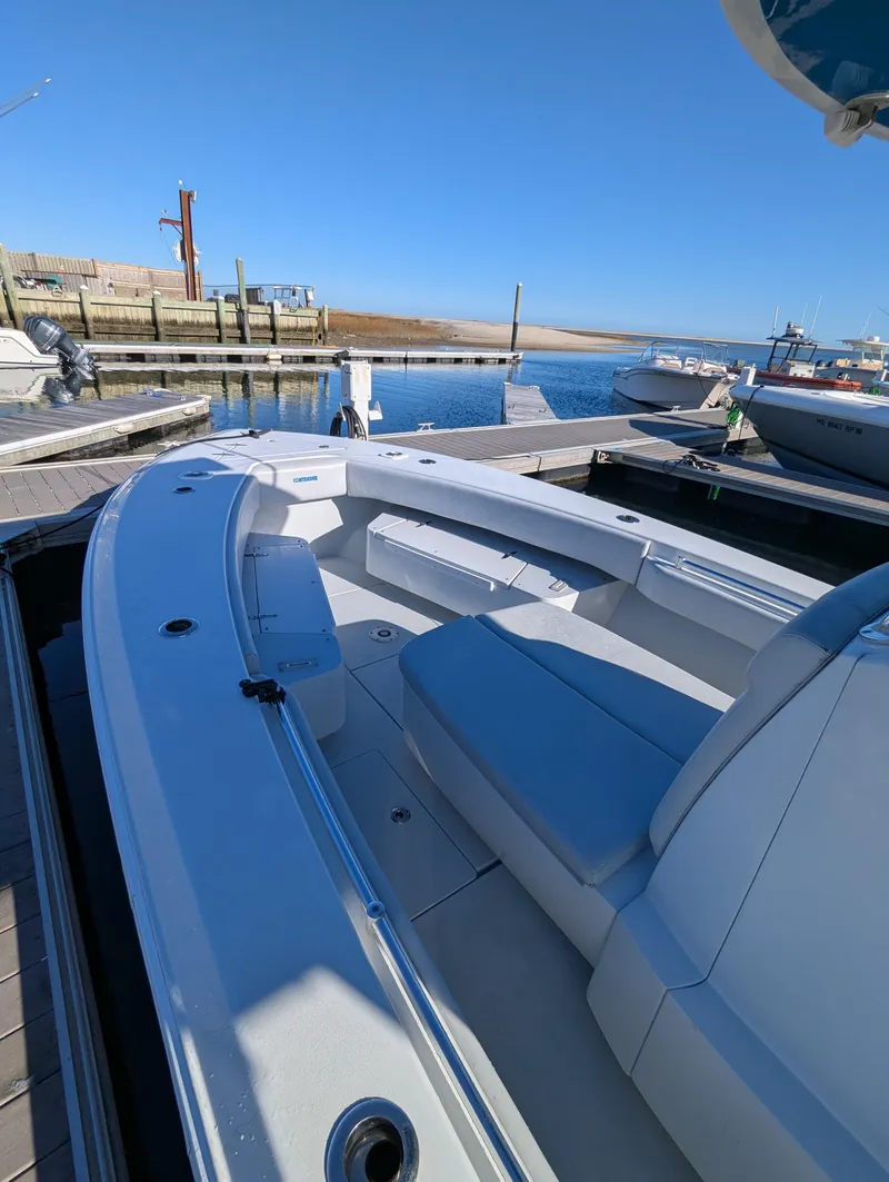 Slide: The Image of 2019 Contender 30T boat docked at a marina under clear blue skies. - 7