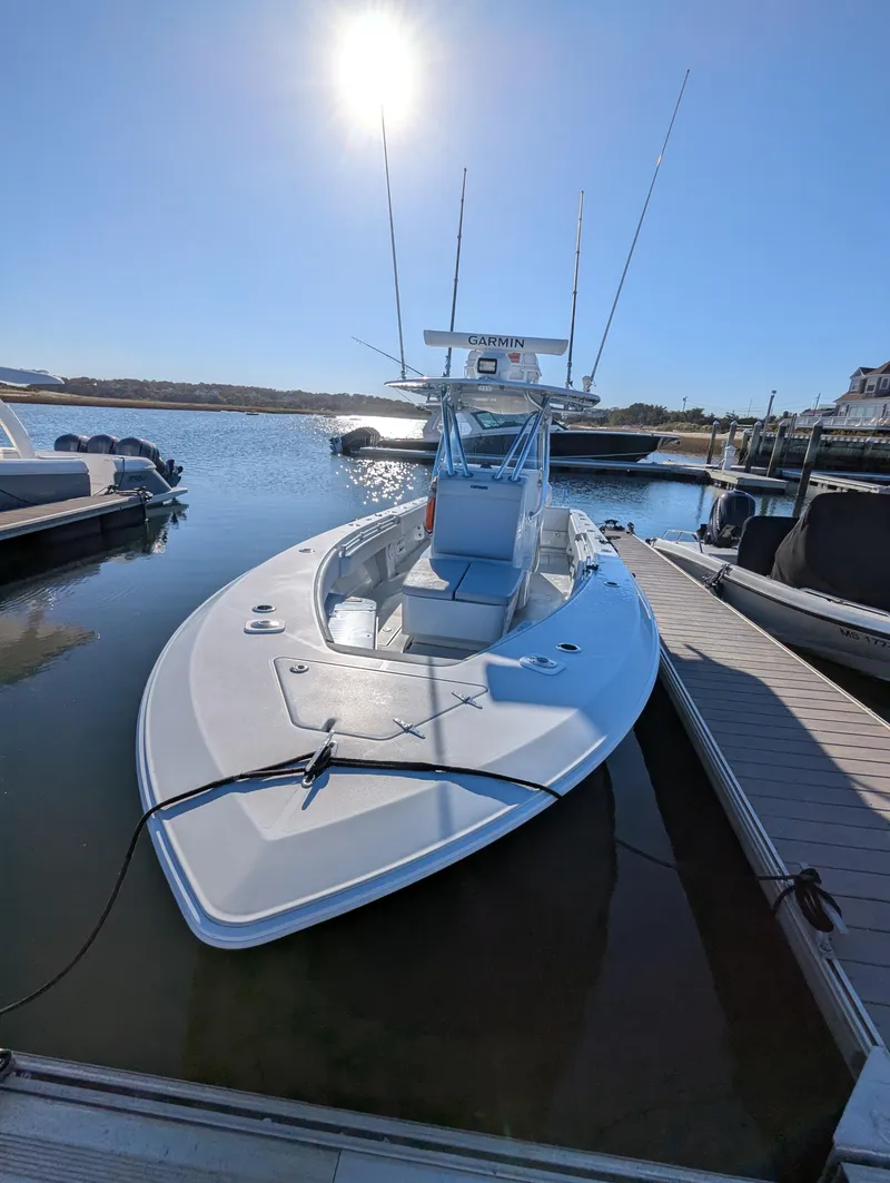 Slide: The Image of 2019 Contender 30T boat docked under bright sun, featuring Garmin equipment. - 8