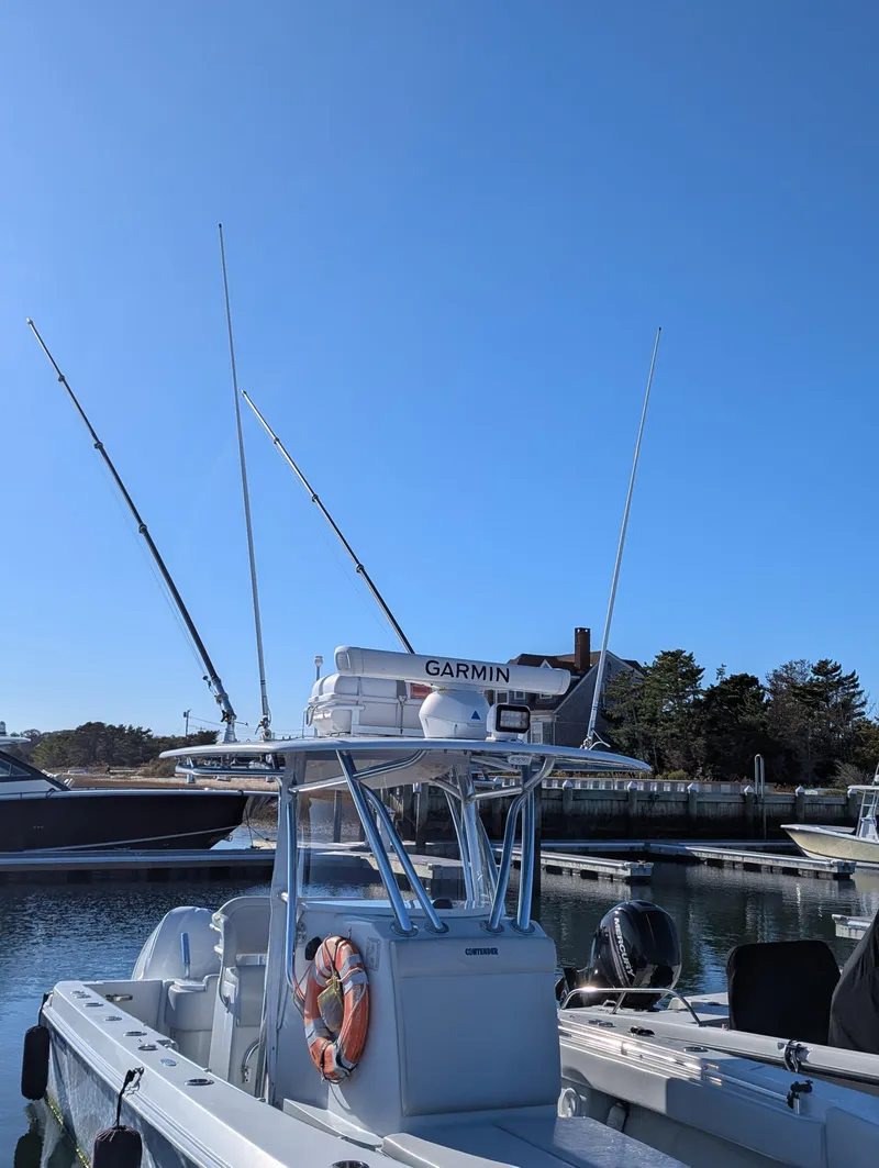 Slide: The Image of 2019 Contender 30T boat with Garmin equipment docked under clear blue sky. - 9