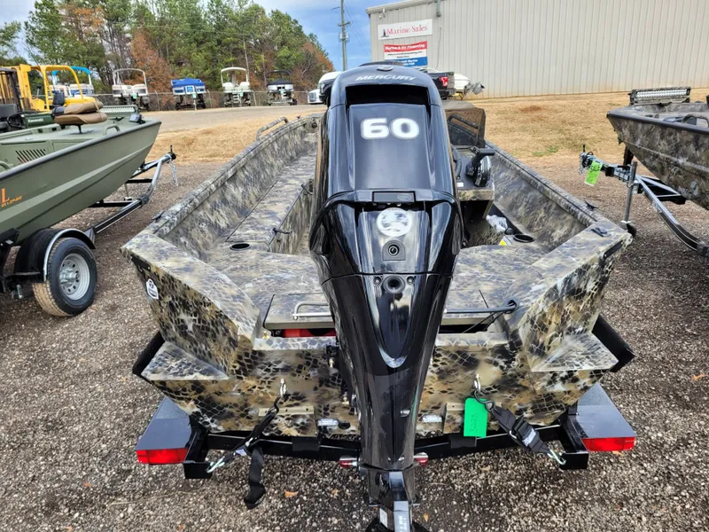 Slide: The Image of 2025 Excel 1651 River Warrior boat with 60HP motor, camo design, parked outdoors. - 7