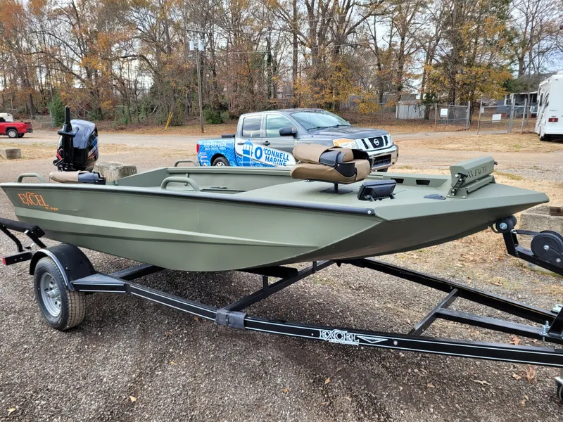 The Image of 2025 Excel Eclipse boat on trailer, parked outdoors with trees in background. - 0