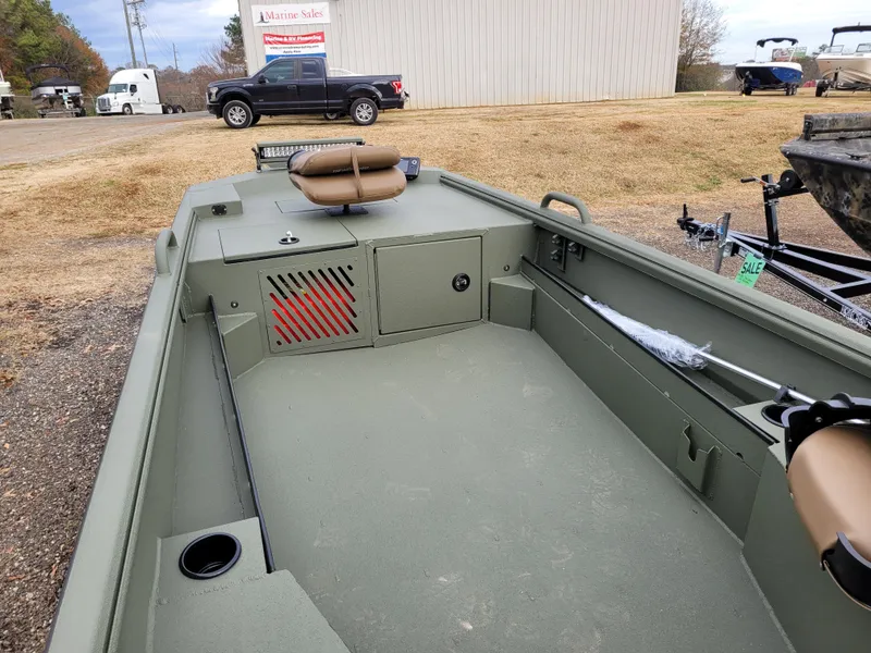 Slide: The Image of 2025 Excel Eclipse boat interior with seating and storage, parked outdoors. - 6