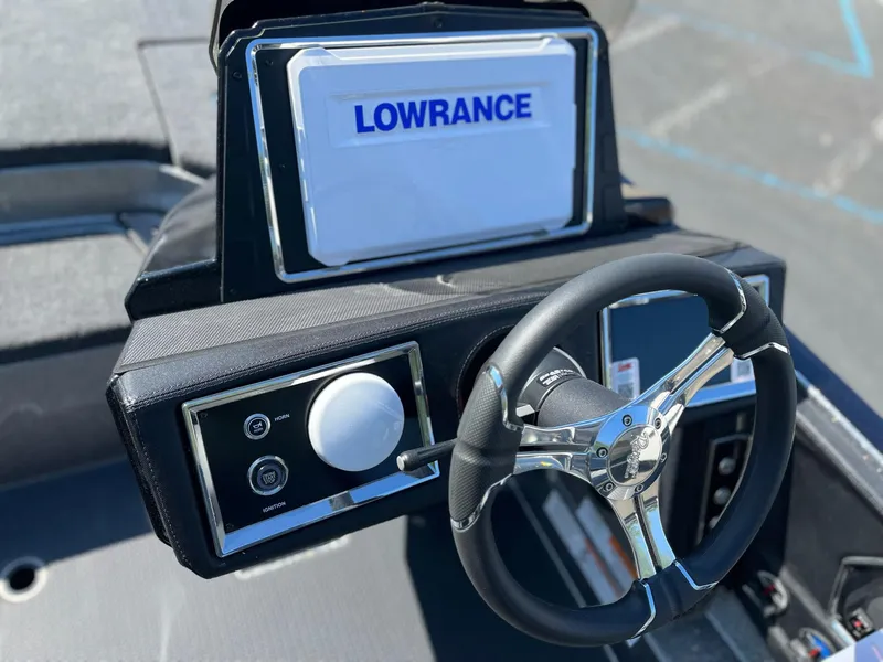 Slide: The Image of 2024 Ranger Z521R boat dashboard with Lowrance display and steering wheel. - 10