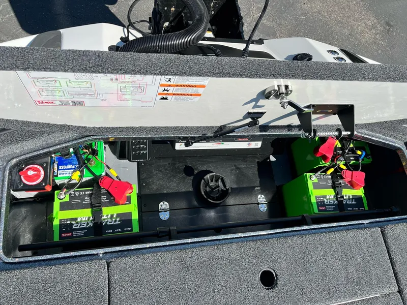 Slide: The Image of 2024 Ranger Z521R boat battery compartment with green batteries and wiring. - 15