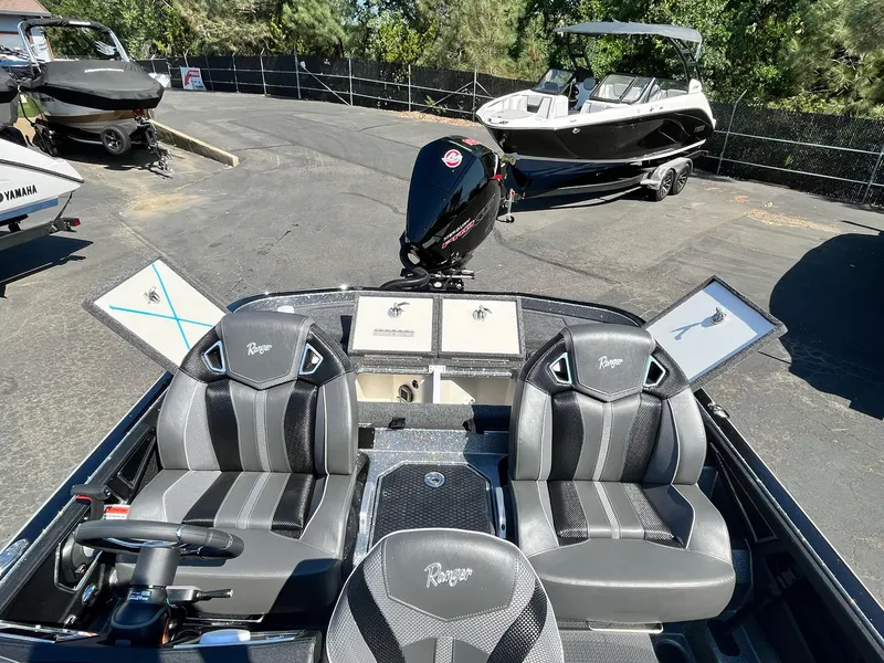 Slide: The Image of 2024 Ranger Z521R Ranger Cup Equipped boat with dual seats and motor, parked outdoors. - 17