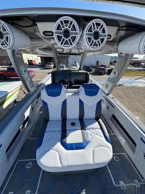 Slide: The Image of 2025 Statement 380 Open boat interior with blue and white seating and overhead speakers. - 2
