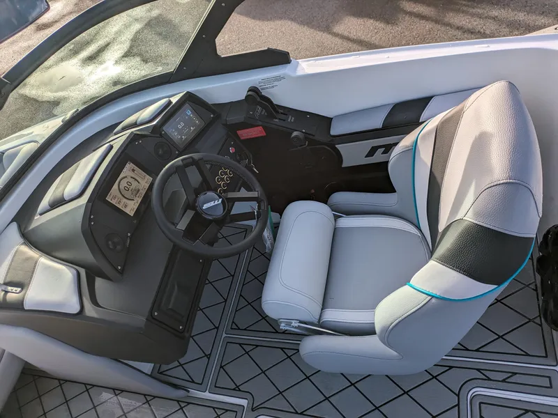 Slide: The Image of 2025 MB B52-23 Alpha boat interior with modern steering and seating. - 13