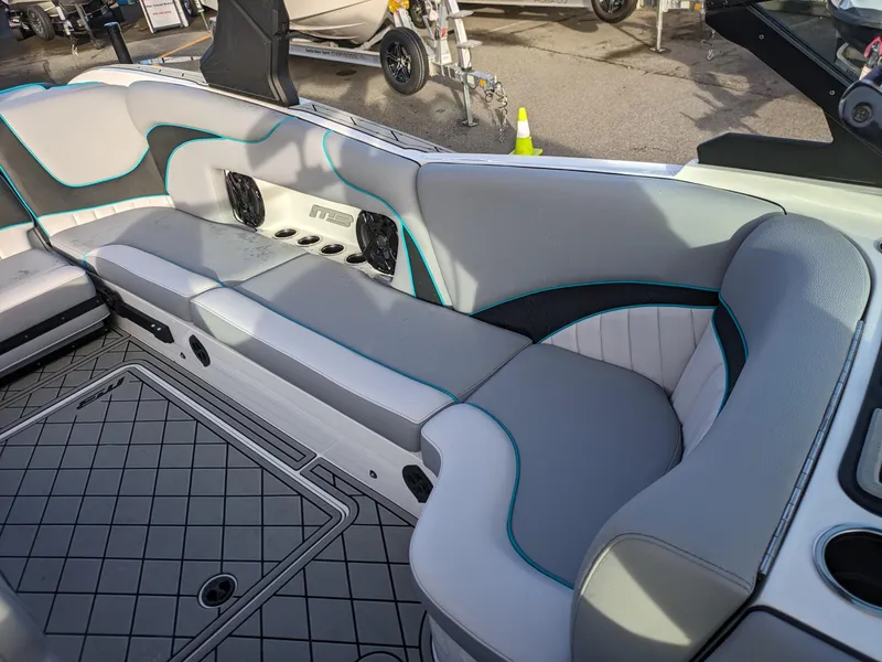 Slide: The Image of 2025 MB B52-23 Alpha boat interior with gray and teal seating, modern design. - 16