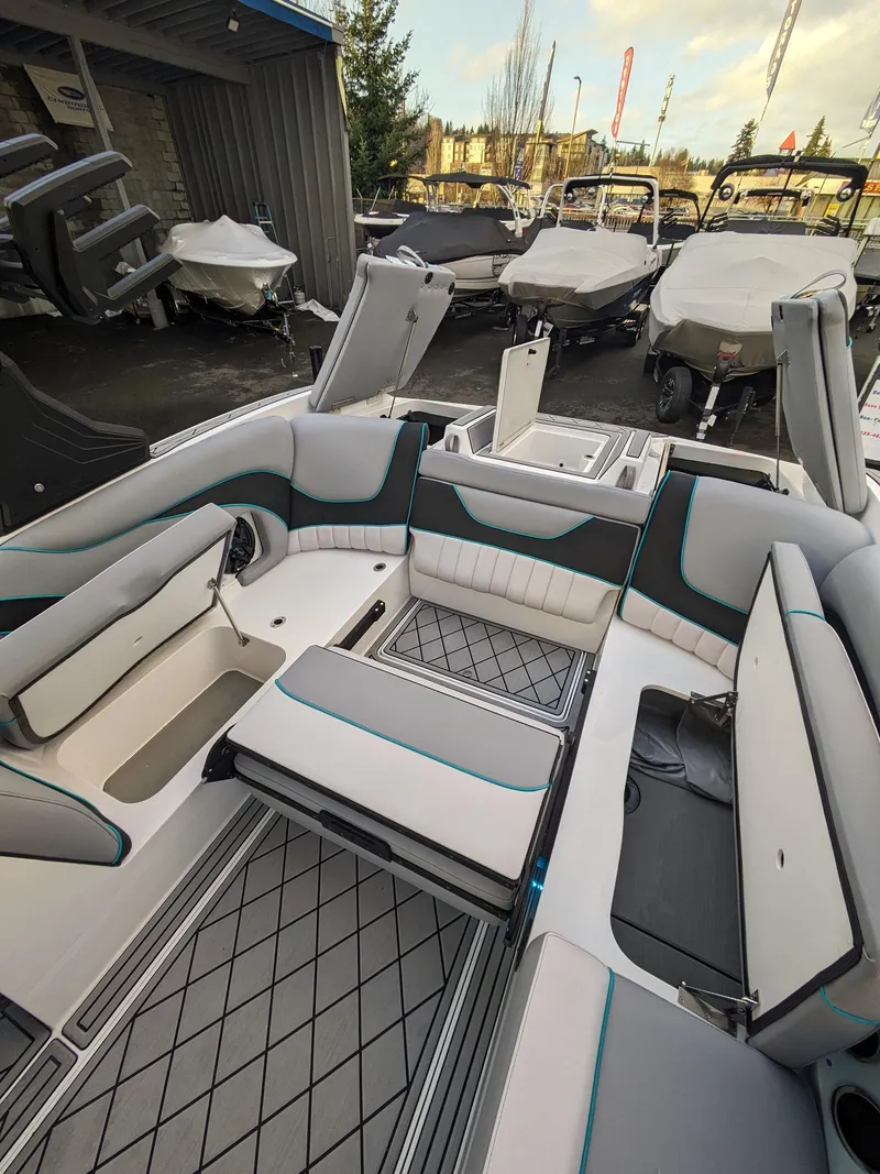 Slide: The Image of 2025 MB B52-23 Alpha boat interior with modern seating and storage features. - 24