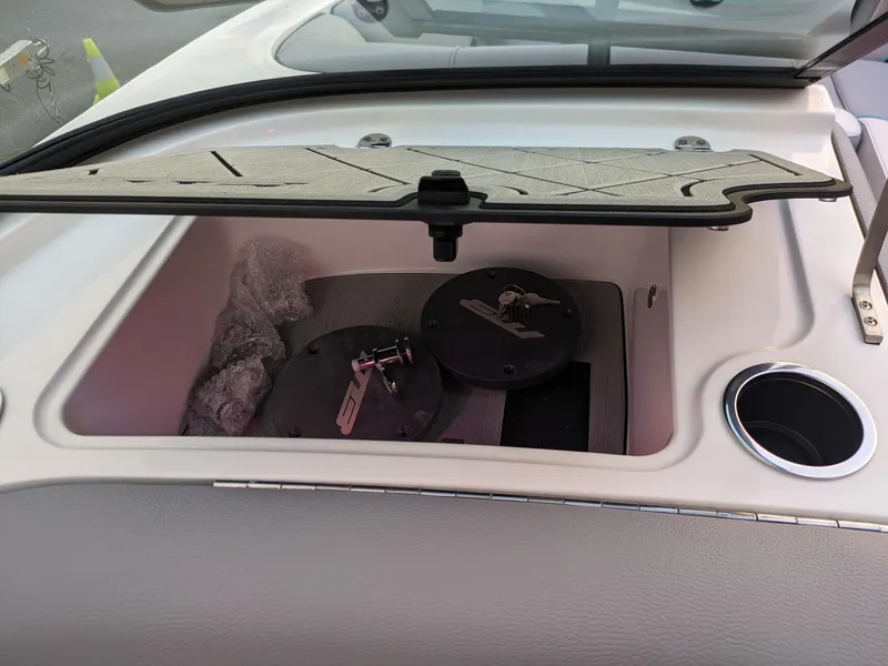 Slide: The Image of 2025 MB B52-23 Alpha storage compartment with open lid and cup holder. - 29