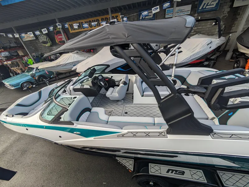 Slide: The Image of 2025 MB B52-23 Alpha boat with sleek design and modern features, parked in showroom. - 7