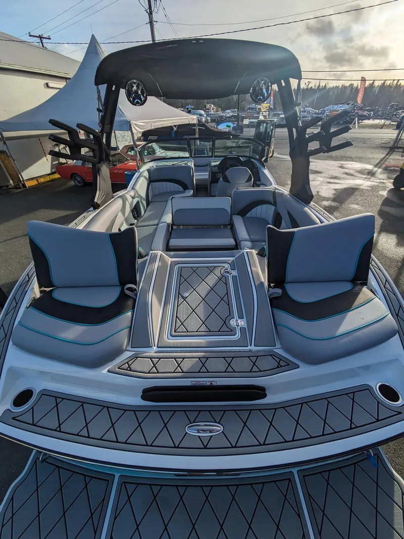 Slide: The Image of 2025 MB B52-23 Alpha boat with sleek design and modern seating at a marina. - 9