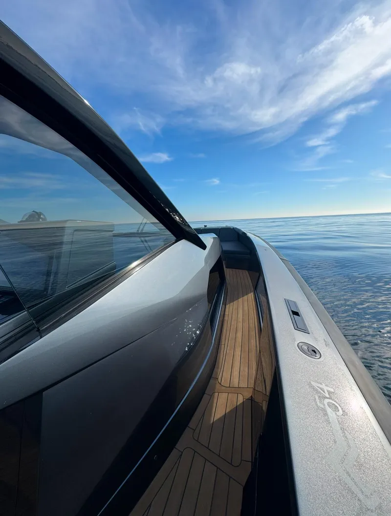 Slide: The Image of Sleek 2019 Maori 54ft Family yacht cruising on calm waters under a clear blue sky. - 7