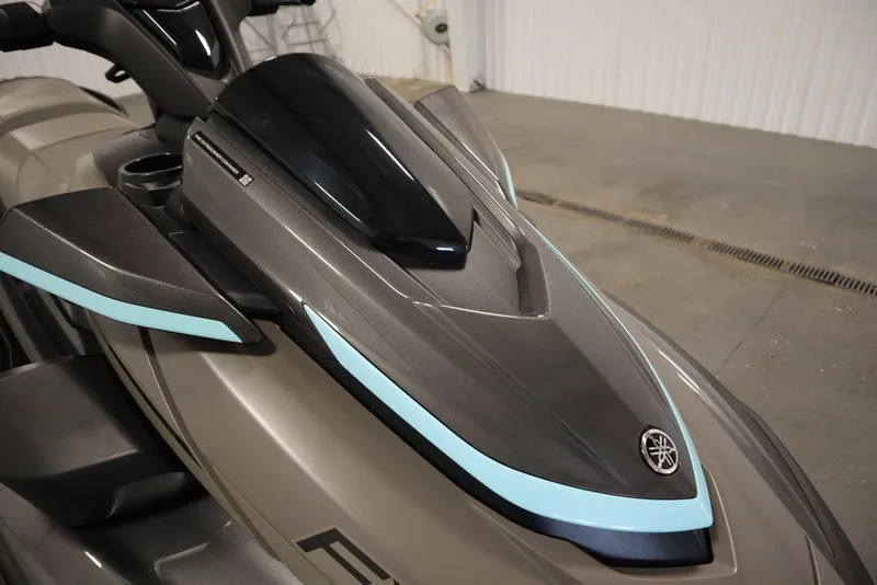 Slide: The Image of 2025 Yamaha WaveRunner FX® HO Audio, sleek design with blue accents, in a showroom. - 8