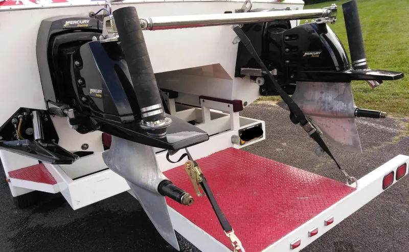Slide: The Image of 1999 Skater 32 boat with dual Mercury outboard engines on a red trailer. - 11