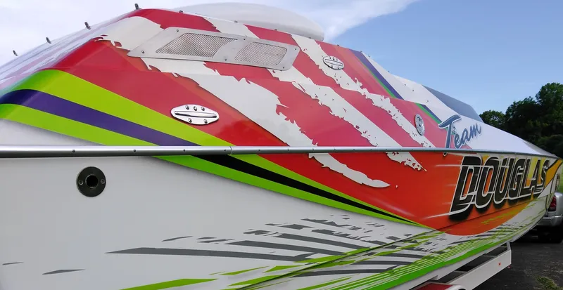 Slide: The Image of Colorful 1999 Skater 32 boat with vibrant graphics and sleek design. - 13