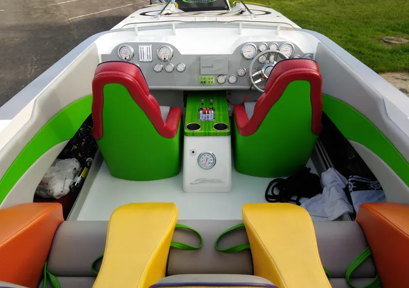 Slide: The Image of Colorful interior of a 1999 Skater 32 boat with vibrant seats and dashboard. - 14