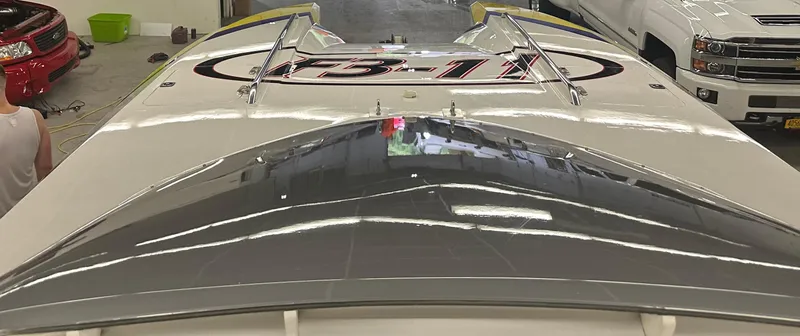 Slide: The Image of 1999 Skater 32 boat in garage, top view with sleek design and graphics. - 16