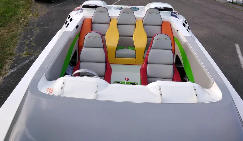 Slide: The Image of 1999 Skater 32 boat with colorful seating and sleek design. - 17
