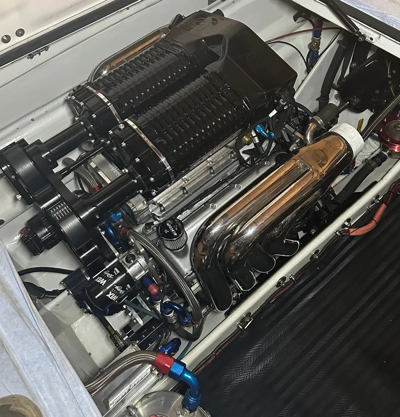 Slide: The Image of Engine of a 1999 Skater 32 Skater boat with chrome components and dual superchargers. - 18