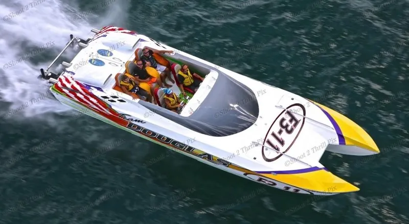Slide: The Image of 1999 Skater 32 powerboat speeding on water with passengers, vibrant design. - 2
