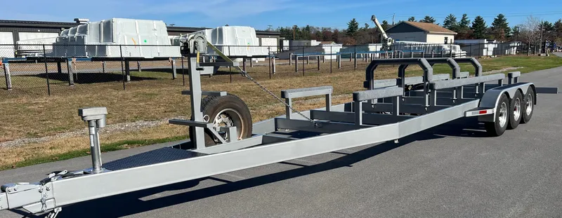 Slide: The Image of 1999 Skater 32 Skater boat trailer with triple axles on a sunny day. - 20