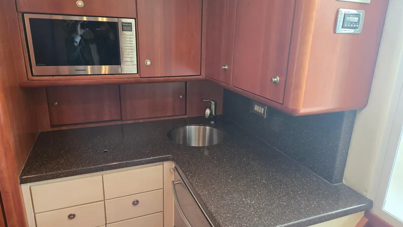 Slide: The Image of Compact kitchen area in 2008 Ocean Yachts 37 Billfish with microwave and sink. - 26