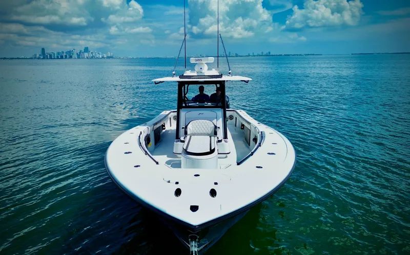 Slide: The Image of 2024 Yellowfin 39 Offshore boat on calm ocean with city skyline. - 13