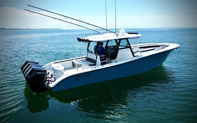 Slide: The Image of 2024 Yellowfin 39 Offshore boat on calm water, featuring triple outboard engines. - 14