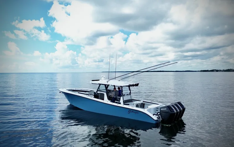 Slide: The Image of 2024 Yellowfin 39 Offshore boat on calm ocean waters under a cloudy sky. - 15