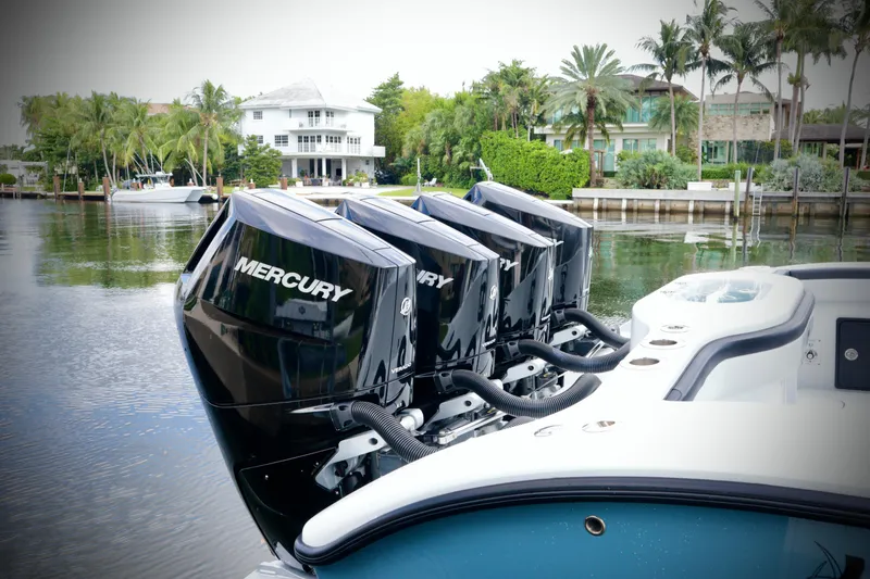 Slide: The Image of 2024 Yellowfin 39 Offshore boat with four Mercury outboard engines docked by waterfront homes. - 17