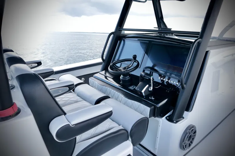 Slide: The Image of 2024 Yellowfin 39 Offshore boat cockpit with modern controls and ocean view. - 19