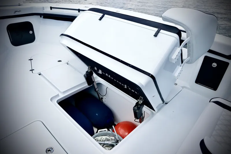 Slide: The Image of 2024 Yellowfin 39 Offshore boat storage compartment with safety equipment. - 23