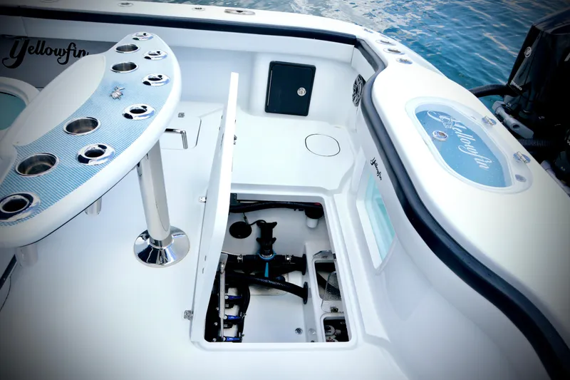 Slide: The Image of 2024 Yellowfin 39 Offshore boat interior with open hatch and fishing rod holders. - 27