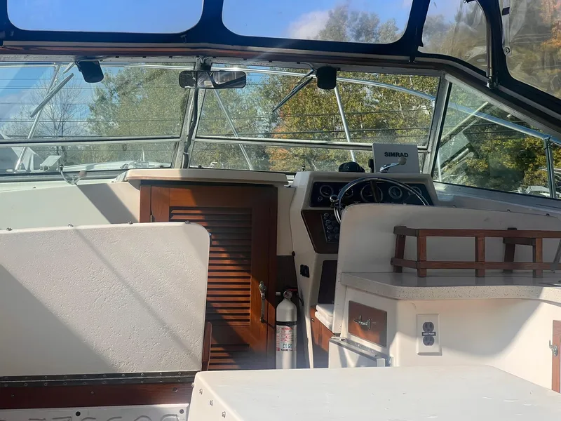 Slide: The Image of Interior of a 1975 Lyman 26 Cruisette boat with steering wheel and dashboard. - 11