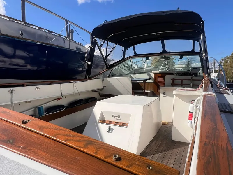 Slide: The Image of 1975 Lyman 26 Cruisette boat interior with wooden accents and canopy. - 16
