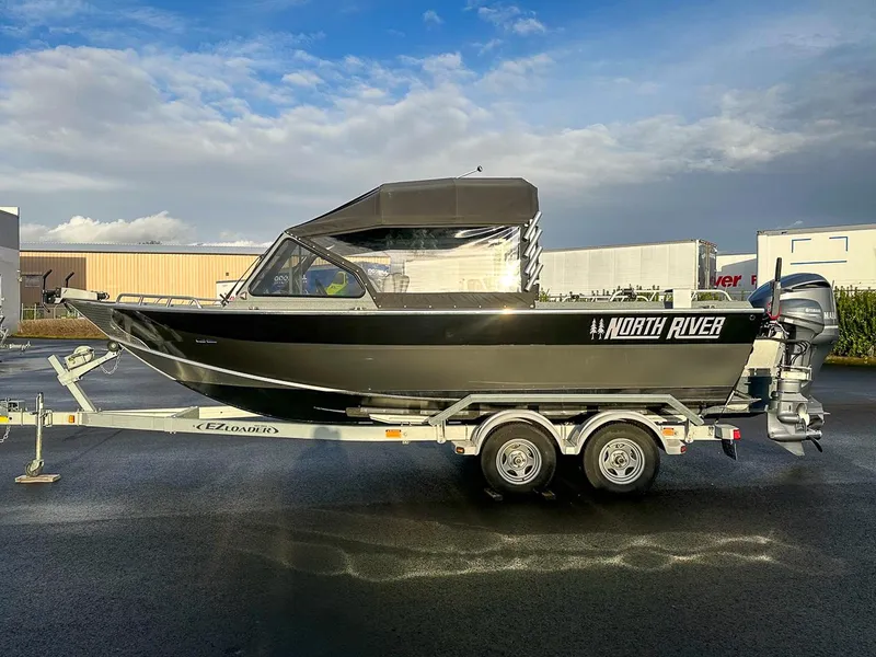 Slide: The Image of 2012 North River 21 SEAHAWK RTF boat on trailer, parked outdoors. - 2