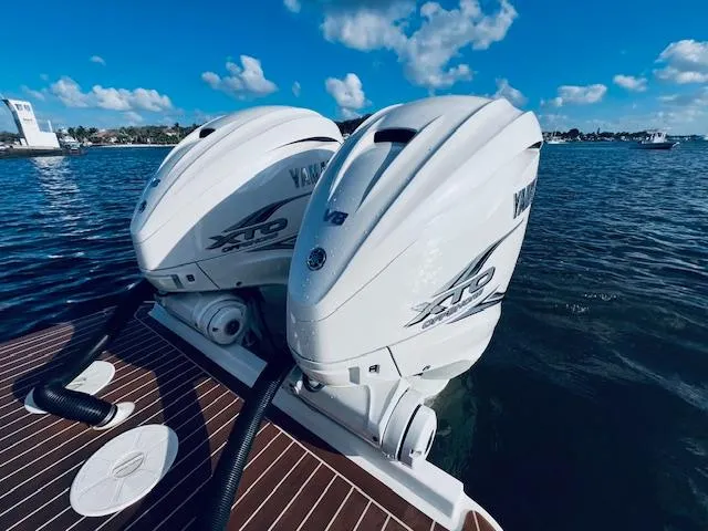 Slide: The Image of Twin Yamaha XTO outboard engines on a 2021 Regulator 34 boat, docked on water. - 10