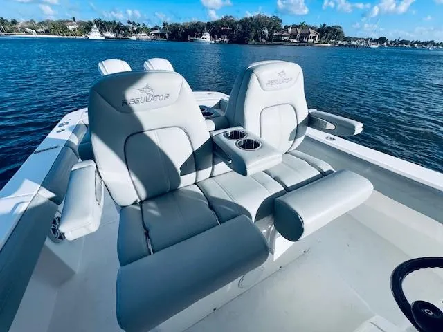 Slide: The Image of 2021 Regulator 34 boat seats on calm water, showcasing luxury and comfort. - 17