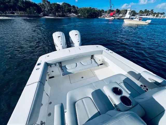 Slide: The Image of 2021 Regulator 34 boat with dual engines on a calm waterway. - 19